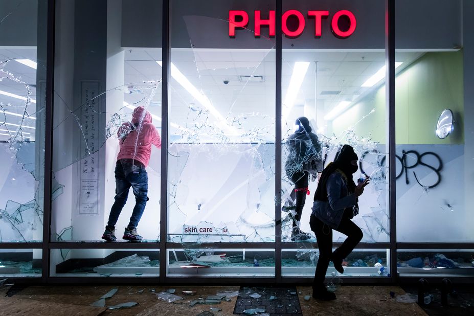 People vandalize a Walgreens store during protests in Oakland, California, on May 29.