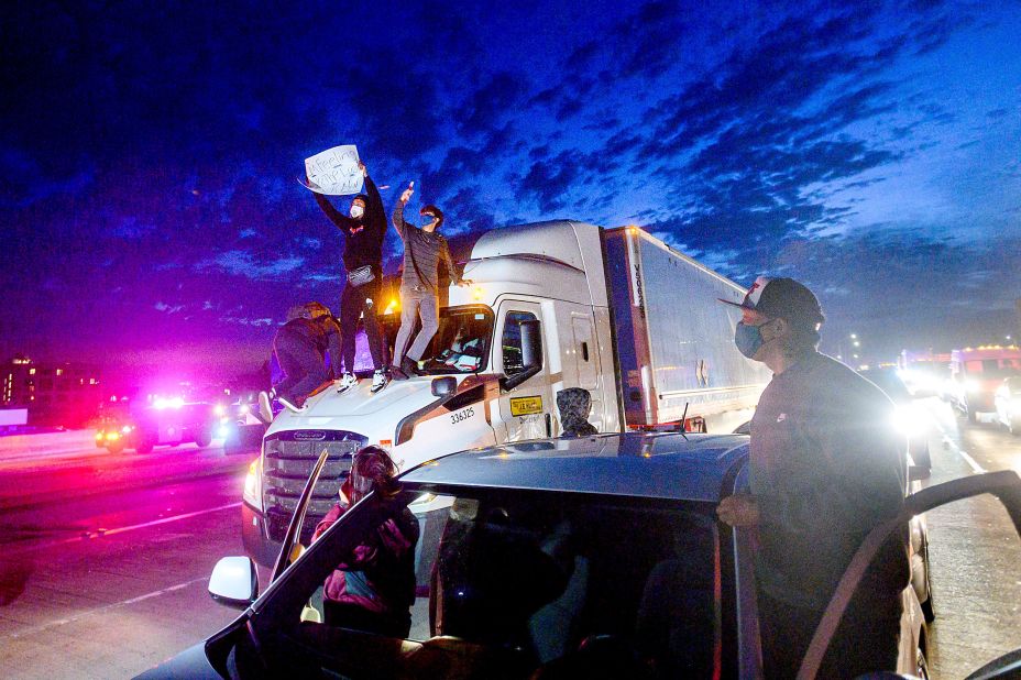 Demonstrators in Oakland climb atop a truck while blocking all lanes of traffic on Interstate 880 on May 29.