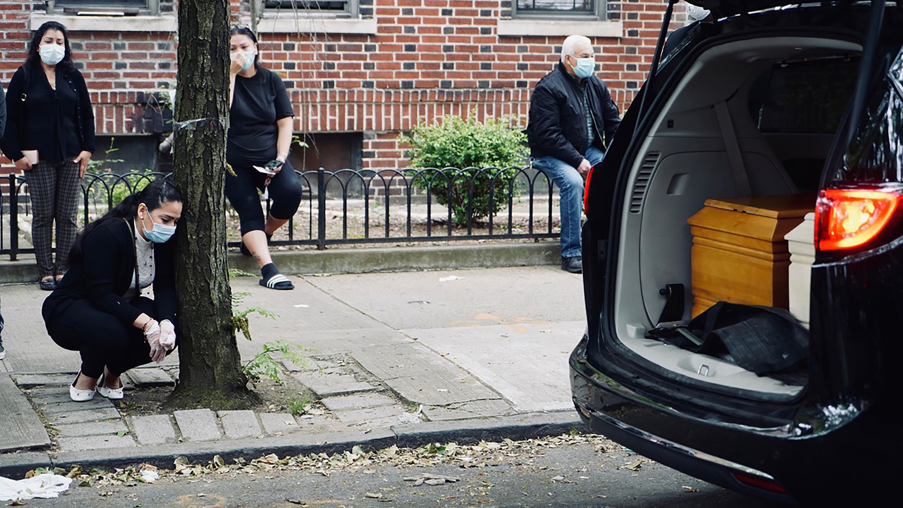 Friends and family wore facemasks and tried to socially distance as they bid farewell to Carlos and Lordes Coronel. The two coffins laid side-by-side in the back of a van that stopped in front their family home in Brooklyn, New York.  