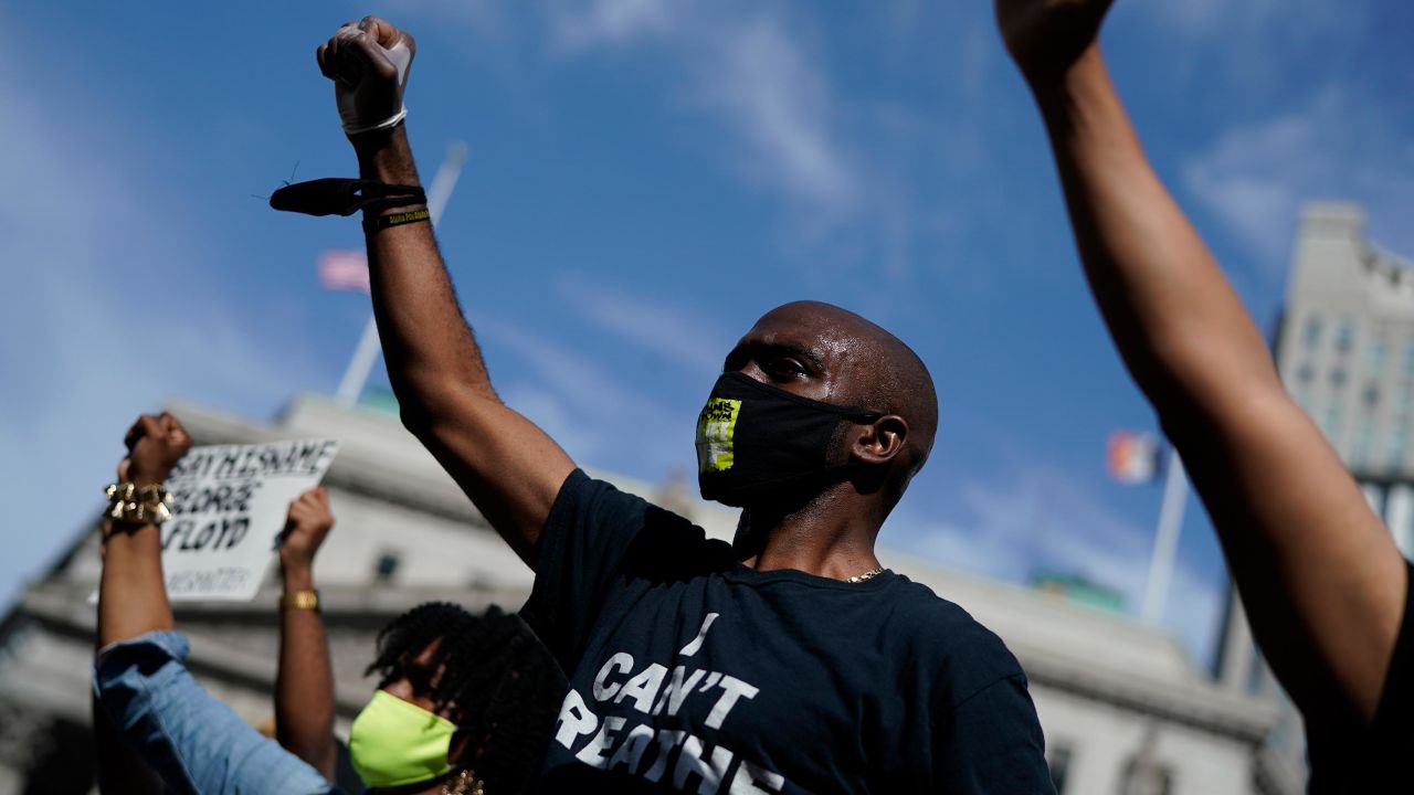 Many demonstrators, like this man at a May vigil in New York, have worn masks while outside. The CDC recommends all Americans wear masks when they can't keep at least six feet of distance from others.