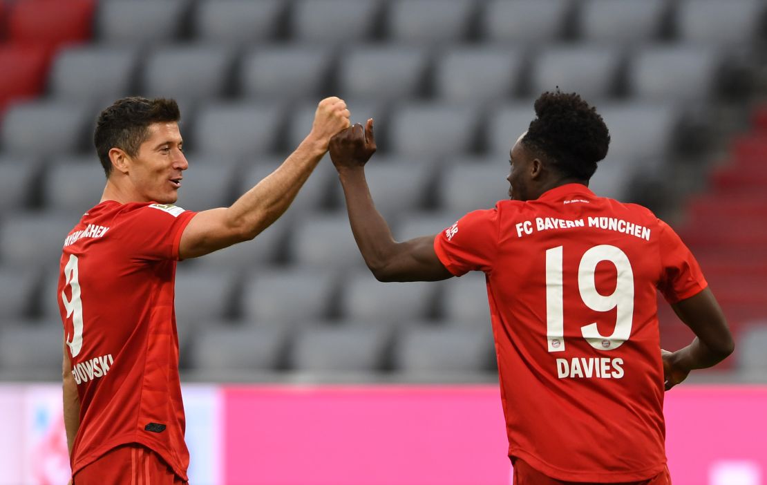 Bayern's Alphonso Davies celebrates with Robert Lewandowski after scoring his team's fifth goal against Fortuna Dusseldorf.