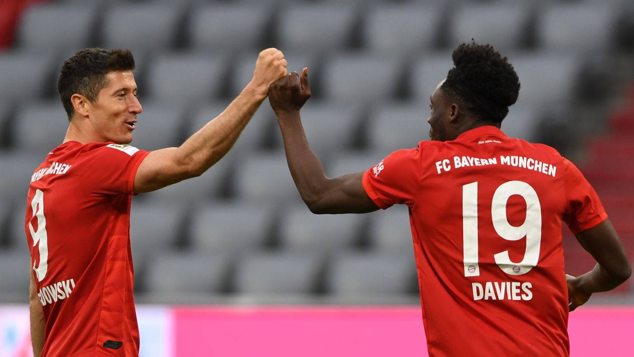 Bayern's Alphonso Davies celebrates with Robert Lewandowski after scoring his team's fifth goal against Fortuna Dusseldorf.