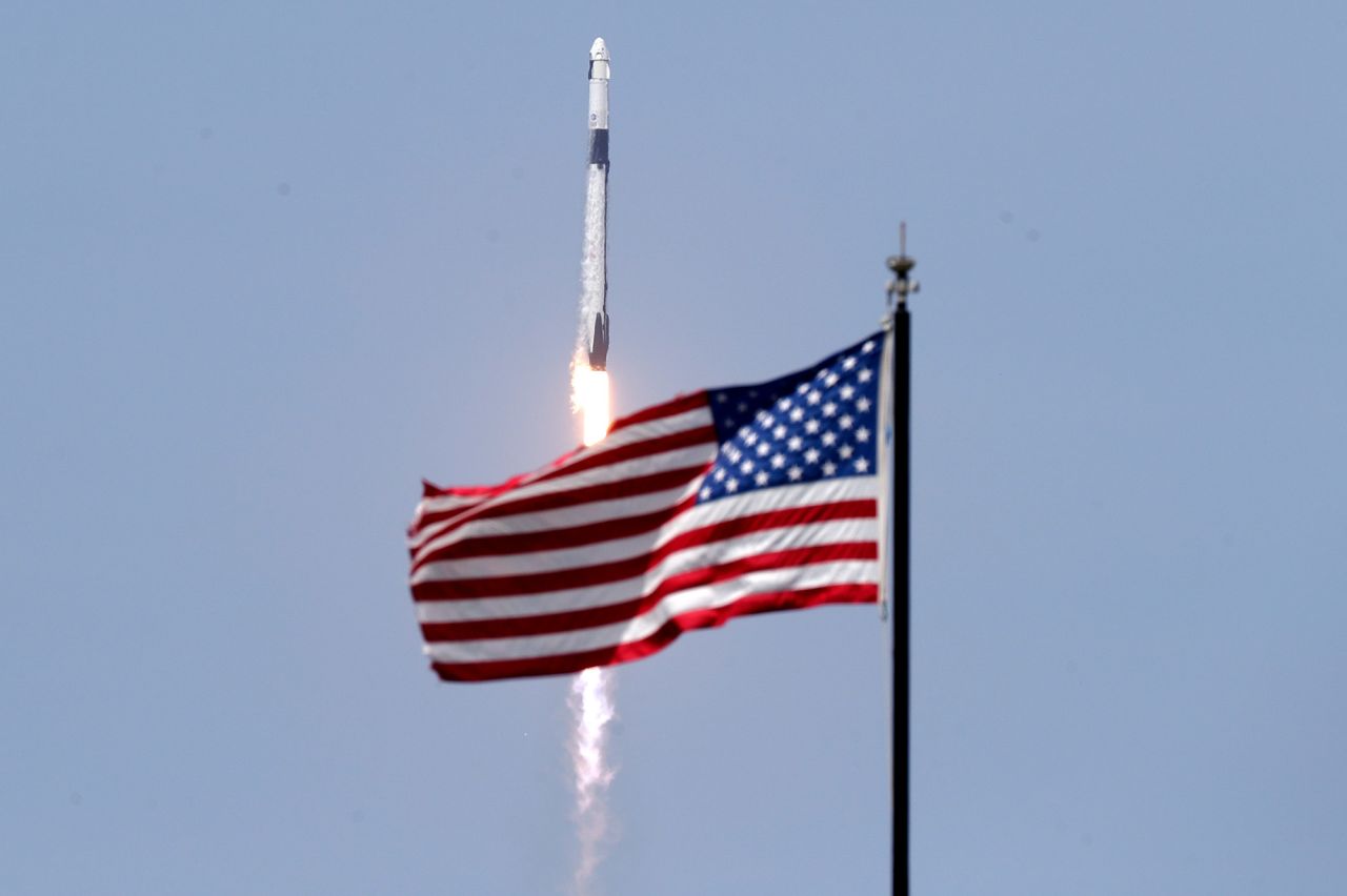An American flag flies as the SpaceX rocket lifts off on May 30.