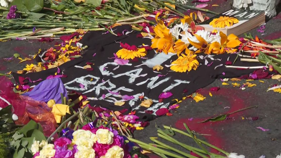 A memorial of flowers and candles grows around the words "I can't breathe" in Minneapolis on May 30, 2020 in response to the death of George Floyd.