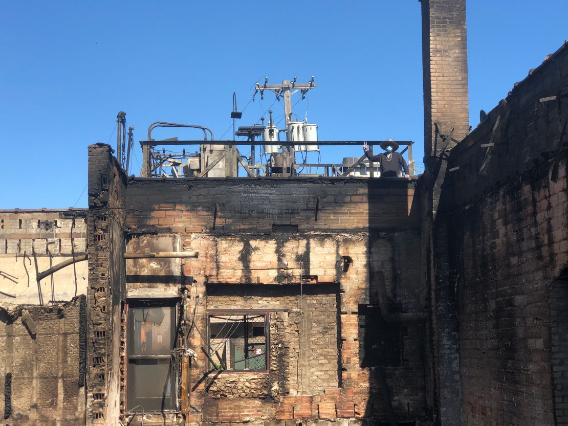 Ruhel Islam standing on the rooftop of what is left of his restaurant, the Gandhi Mahal.