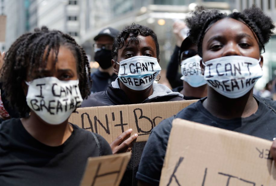 People with signs and masks that read "I can't breathe" attend a protest in Chicago on May 30.
