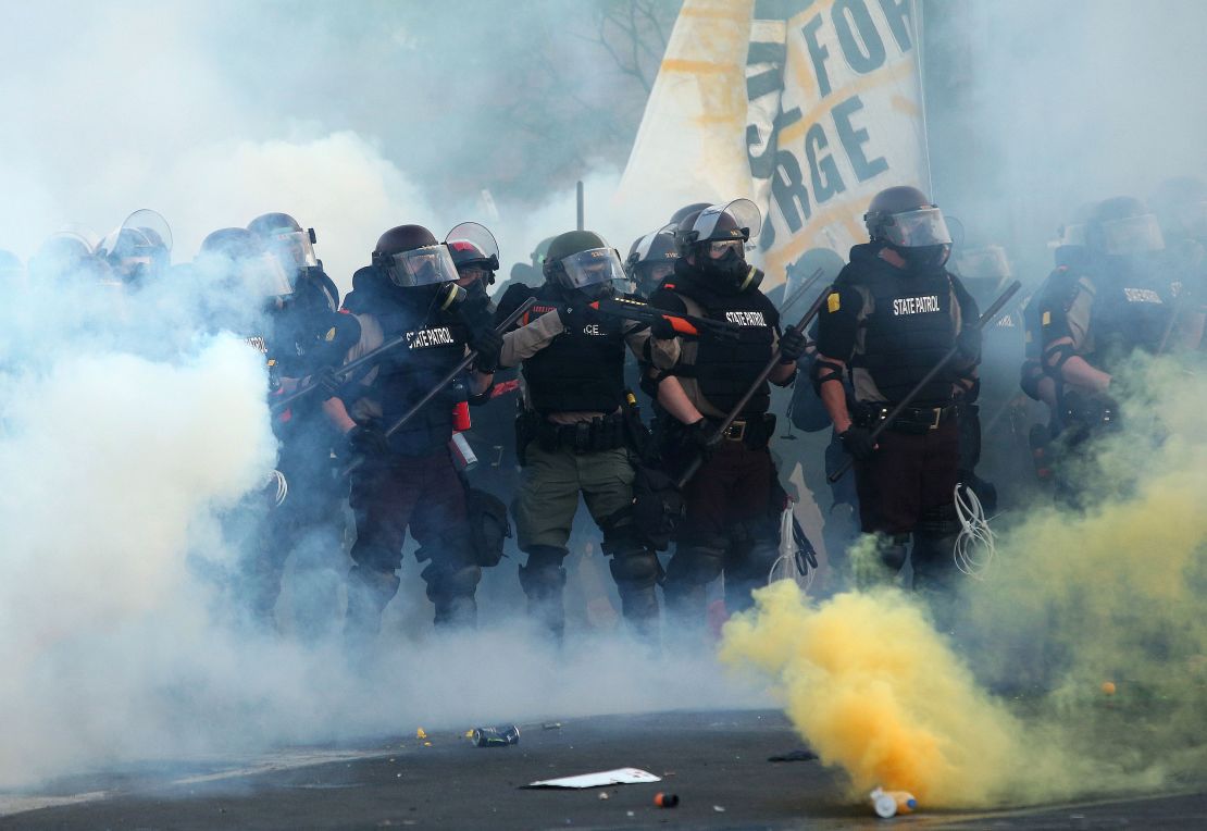 Police in Minneapolis, Minnesota, advance on demonstrators who are protesting the killing of George Floyd. 