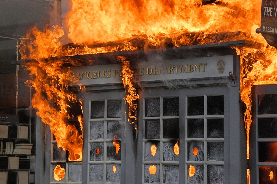 A Los Angeles Police Department kiosk burns in The Grove shopping center during a protest on May 30. 