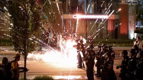 A firework explodes by a police line on Saturday, May 30, near the White House in Washington. 