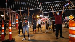 Protesters hold up metal gates as they build a barrier in a roadway on Saturday, May 30, in Las Vegas.