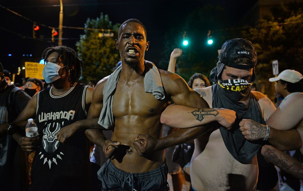 Protesters link arms in Charlotte on May 30.