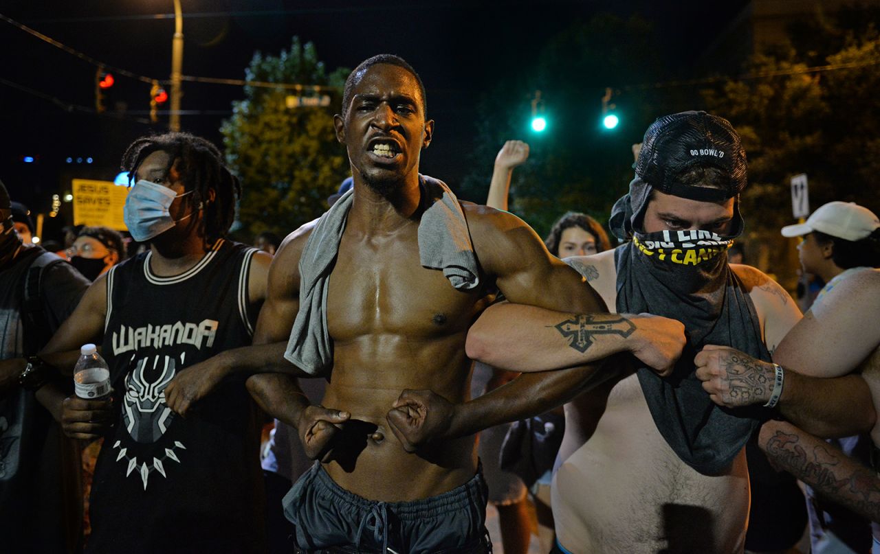 Protesters link arms in Charlotte on May 30.