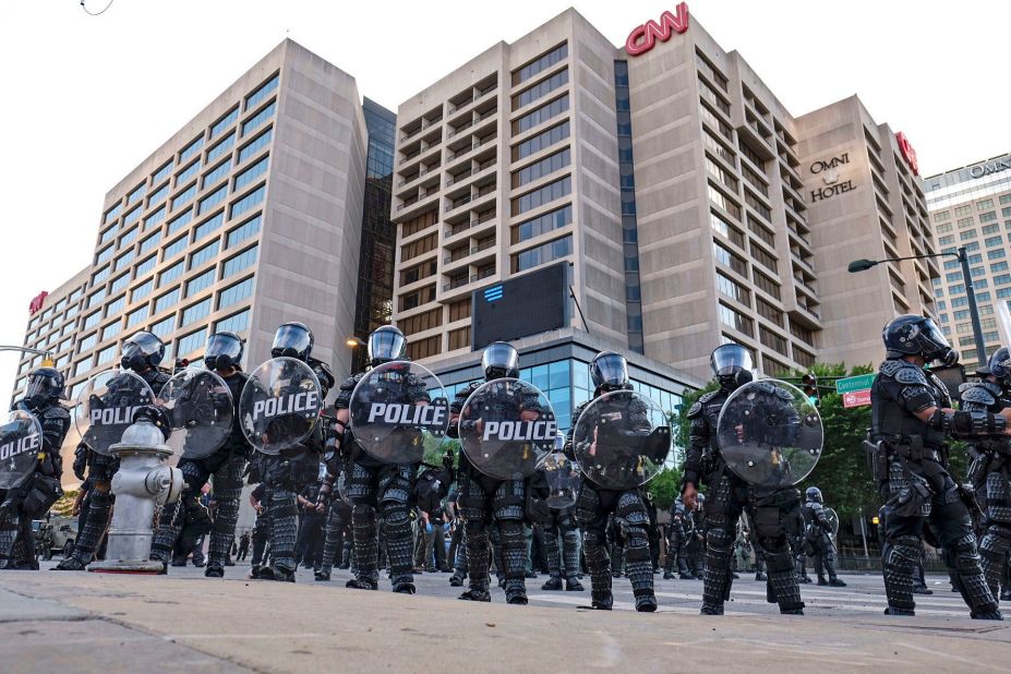 Police stand guard near the CNN Center and Centennial Olympic Park as protests continued in Atlanta on May 30.