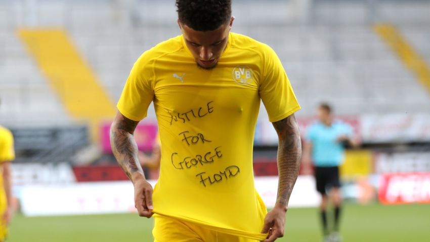 Dortmund's English midfielder Jadon Sancho shows a "Justice for George Floyd" shirt as he celebrates after scoring his team's second goal during the German first division Bundesliga football match SC Paderborn 07 and Borussia Dortmund at Benteler Arena in Paderborn on May 31, 2020.