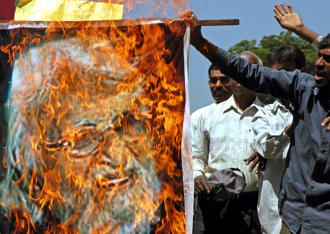 Indian activists from a hardline Hindu group burn a poster of Husain during a protest in Bengaluru, India, in 2006.