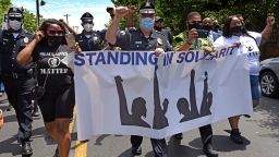 Camden County Metro Police Chief Joe Wysocki raises a fist while participating in a solidarity March Saturday.