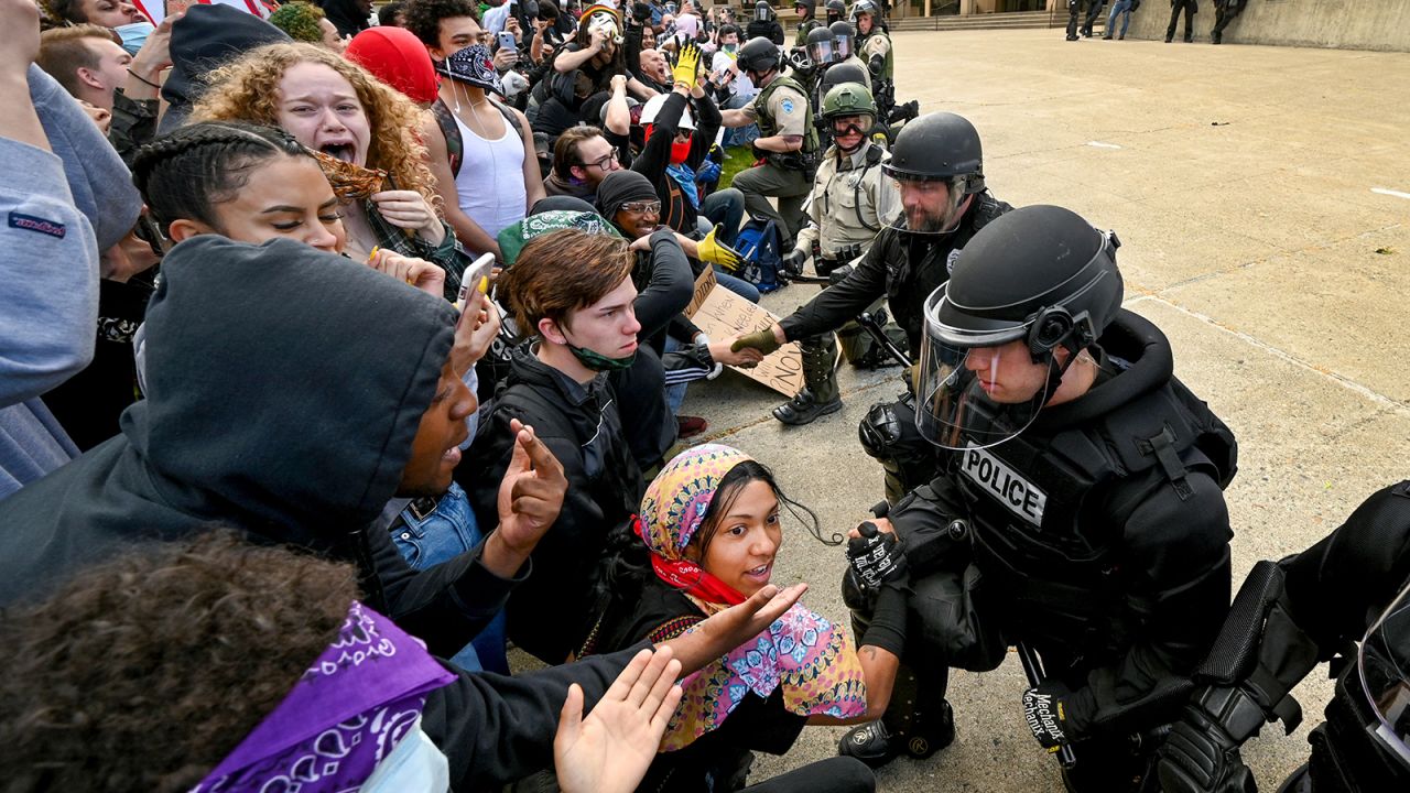 Law enforcement officers were cheered by demonstrators as they knelt in Spokane.