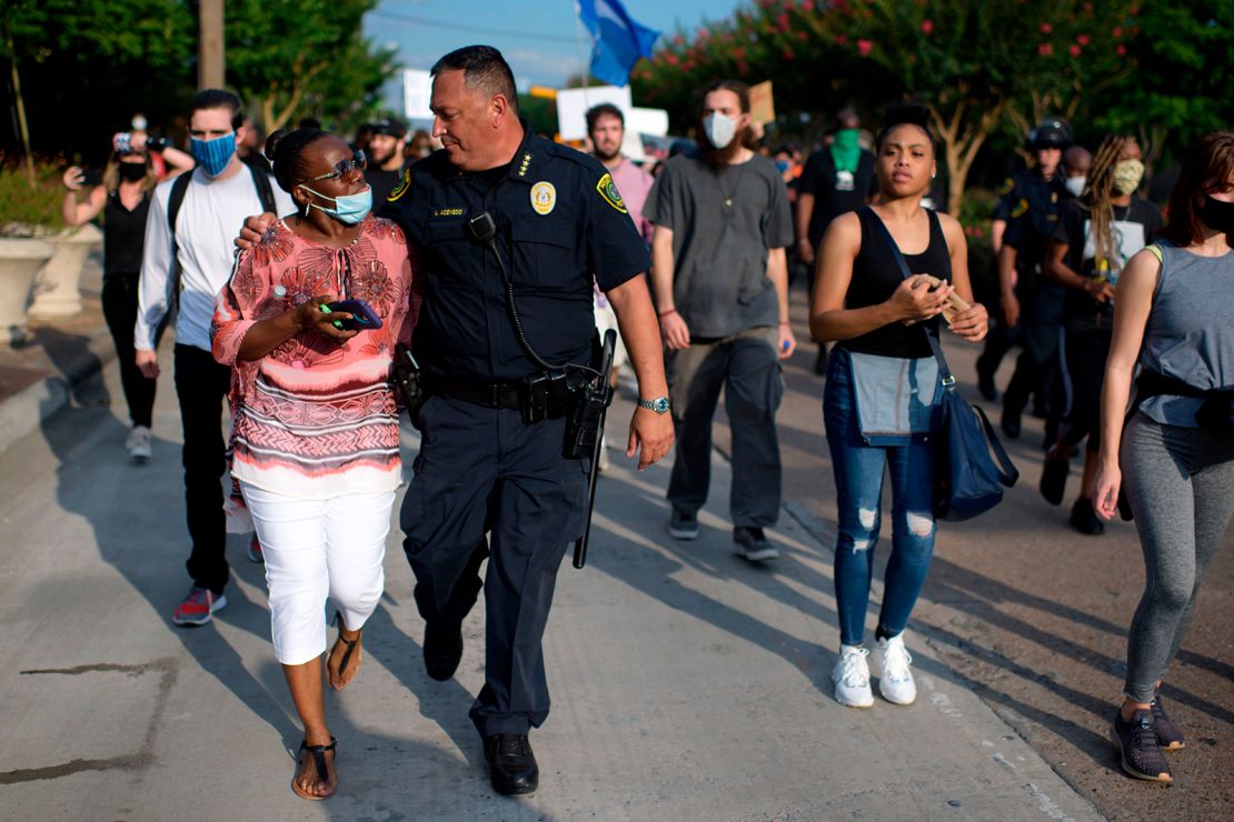 Houston Police Chief Art Acevedo walked arm-in-arm with a woman during a "Justice for George Floyd" event Saturday.