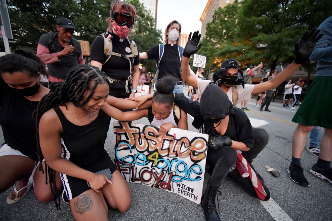 Demonstrators stopped to pray during a protest in Atlanta Friday.