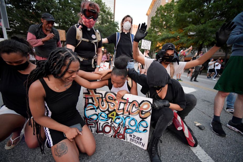 Demonstrators pray during a march in Atlanta.