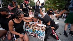 Demonstrators pray during a march, Sunday, May 31, 2020, in Atlanta. Protests continued following the death of George Floyd, who died after being restrained by Minneapolis police officers on May 25. (AP Photo/Mike Stewart)