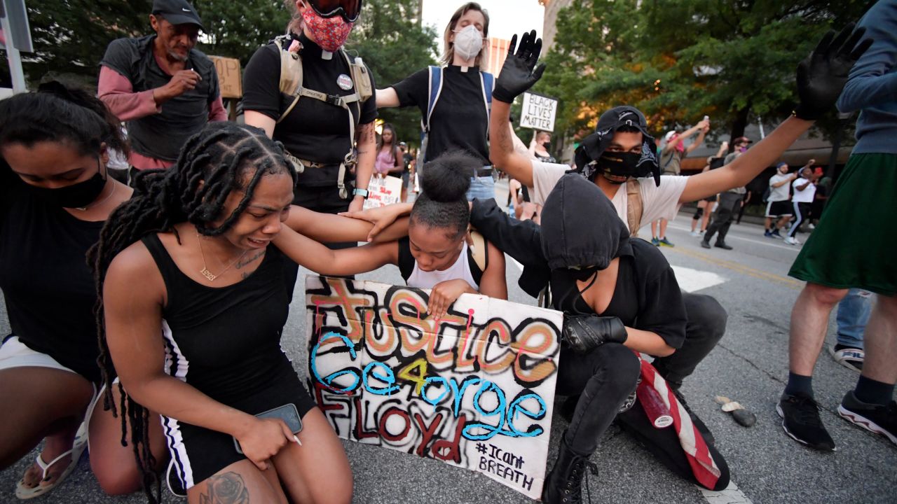 Demonstrators stopped to pray during a protest in Atlanta Friday.