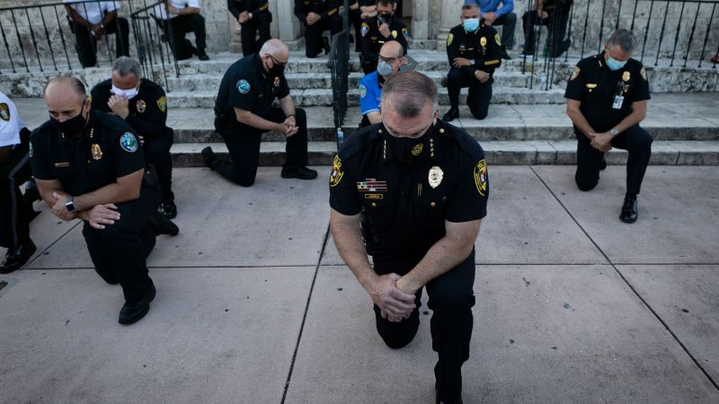 See police officers kneel in solidarity with protesters