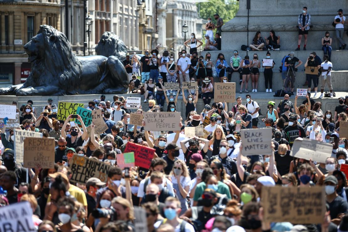 People hold placards as they join a Black Lives Matter march at Trafalgar Square in London on Sunday, May 31.