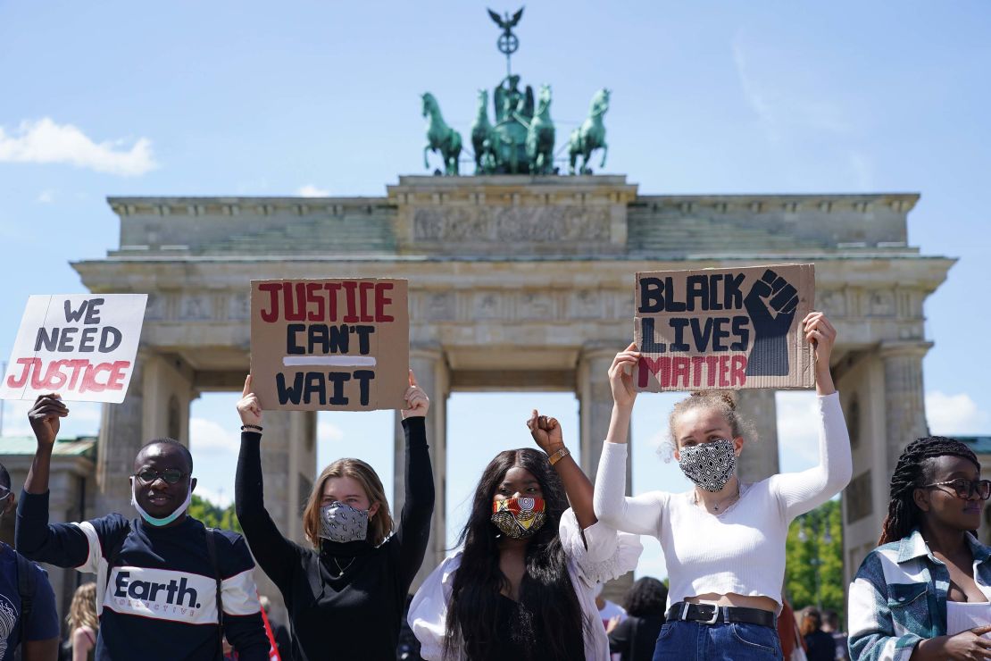 People attend a rally against racism in front of the Brandenburg Gate in Berlin on Sunday, May 31. 