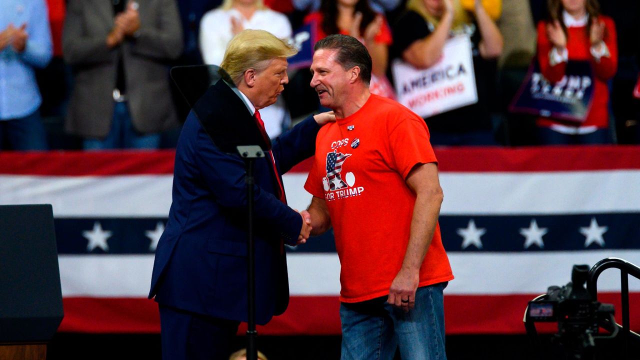 President Donald Trump shakes hands with Minneapolis Police Union head Bob Kroll on stage during a campaign rally at the Target Center on October 10, 2019 in Minneapolis, Minnesota. 