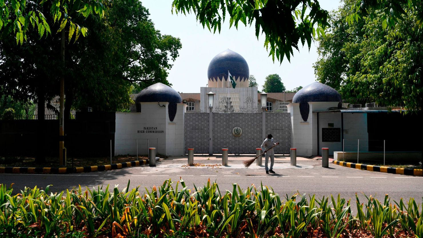 A man sweeps in front of the main gate of the Pakistan High Commission in New Delhi on June 1, 2020.