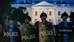 Police stand guard outside the White House as people gather to protest the death of George Floyd, an unarmed black man who died in police custody in Minneapolis, in Washington, DC, on May 31, 2020. - Thousands of National Guard troops patrolled major US cities after five consecutive nights of protests over racism and police brutality that boiled over into arson and looting, sending shock waves through the country. The death Monday of an unarmed black man, George Floyd, at the hands of police in Minneapolis ignited this latest wave of outrage in the US over law enforcement's repeated use of lethal force against African Americans -- this one like others before captured on cellphone video. (Photo by Samuel Corum / AFP) (Photo by SAMUEL CORUM/AFP via Getty Images)