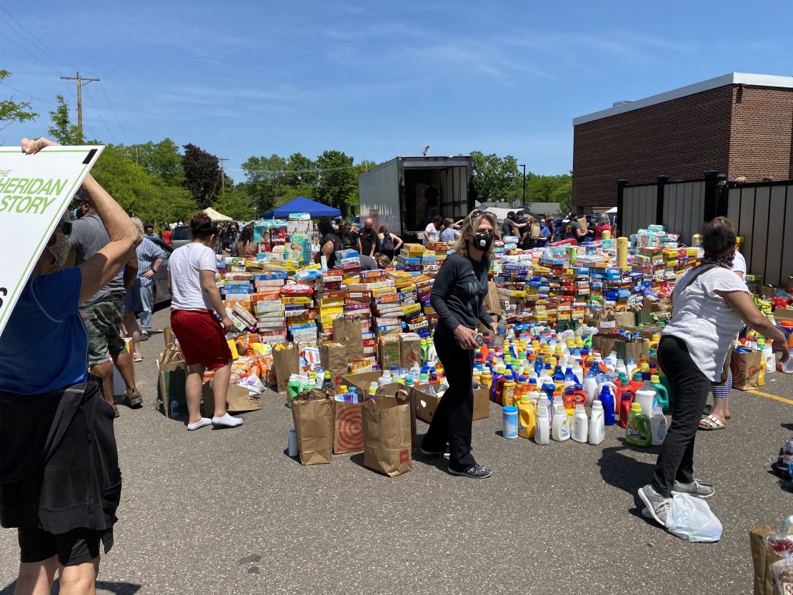 Volunteers sort donated groceries and supplies for families who live in the areas damaged by looting and protests.