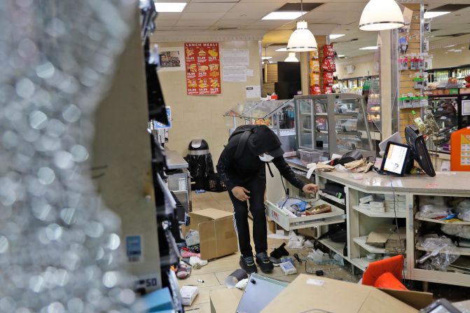 A person is seen inside a damaged 7-Eleven store in New York on May 31.