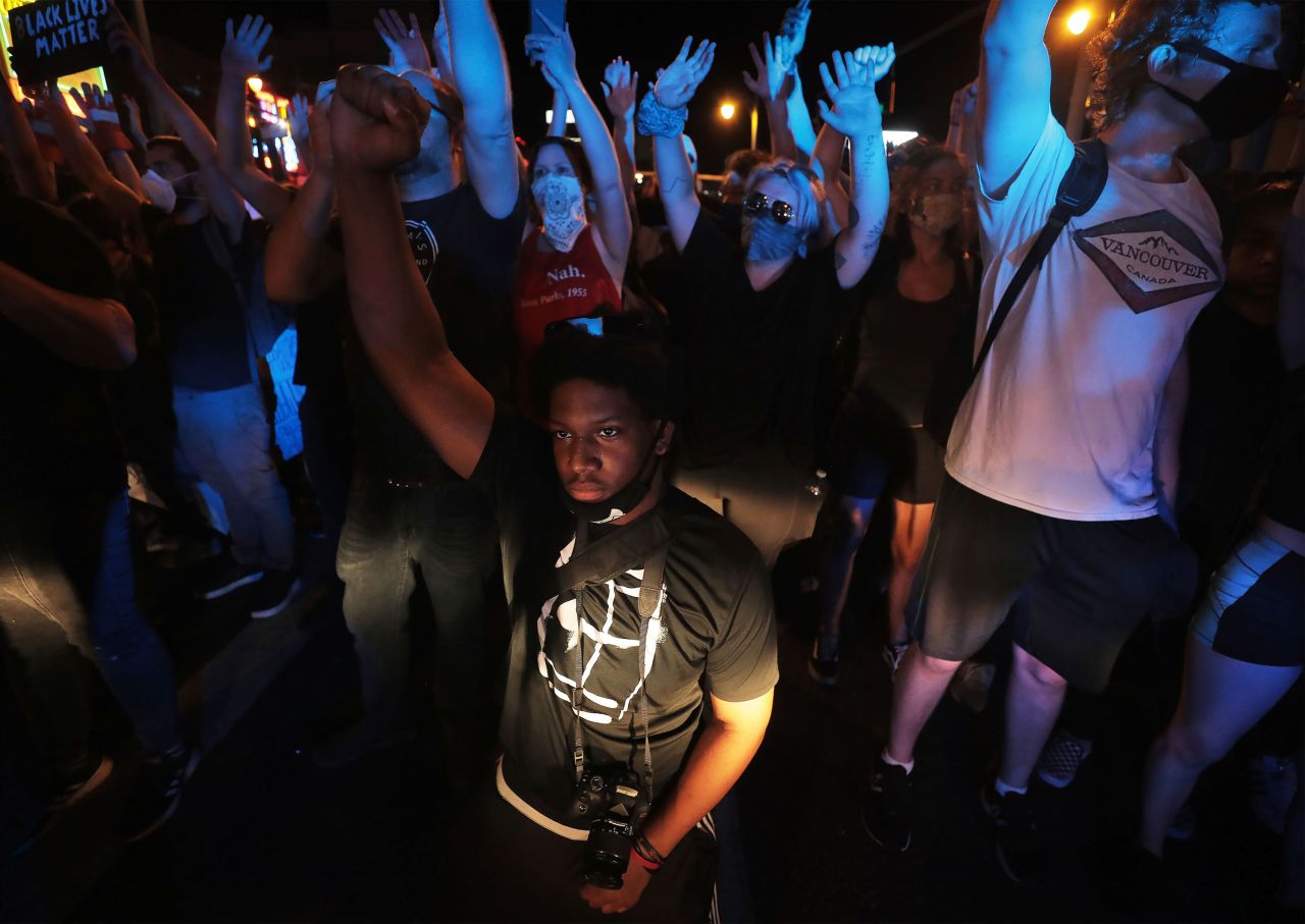 A protester kneels in front of a police line in Memphis on May 31.