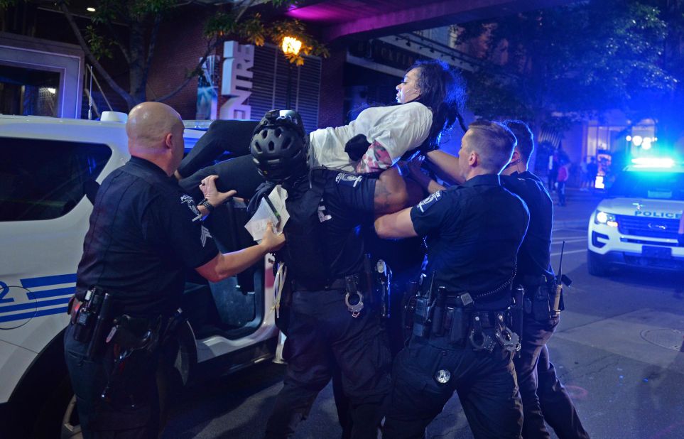 A woman is carried by police in Charlotte, North Carolina, on May 31.