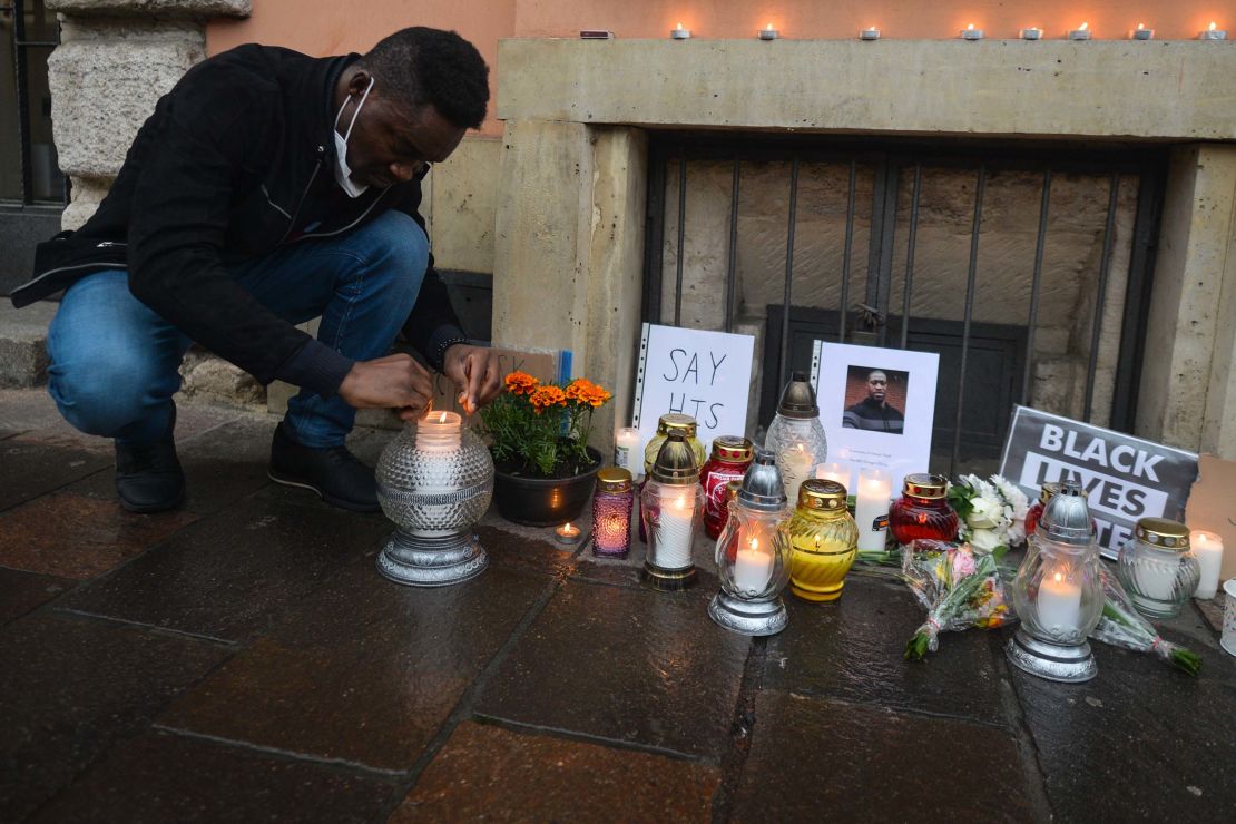 A man lights a candle in front of the US Consulate in Krakow on Sunday, May 31.
