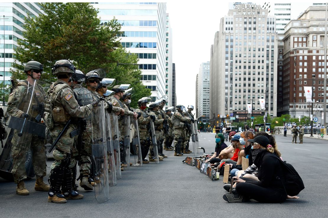 Protesters rally in front of Pennsylvania National Guard soldiers, Monday, June 1, 2020, in Philadelphia, over the death of George Floyd.