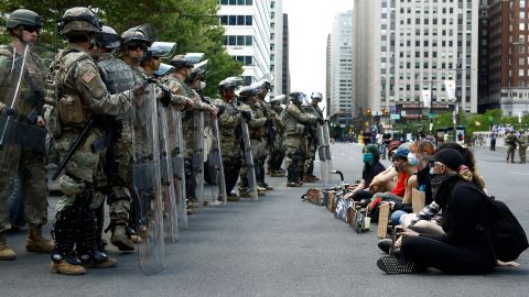 Protesters rally in front of Pennsylvania National Guard soldiers, Monday, June 1, 2020, in Philadelphia, over the death of George Floyd.