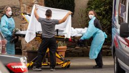 SEATTLE, WA - FEBRUARY 29: Healthcare workers transport a patient on a stretcher into an ambulance at Life Care Center of Kirkland on February 29, 2020 in Kirkland, Washington. Dozens of staff and residents at Life Care Center of Kirkland are reportedly exhibiting coronavirus-like symptoms, with two confirmed cases of (COVID-19) associated with the nursing facility reported so far. (Photo by David Ryder/Getty Images)