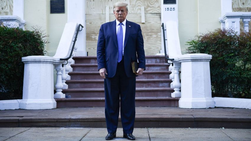 US President Donald Trump holds up a bible in front of boarded up St John's Episcopal church after walking across Lafayette Park from the White House in Washington, DC on June 1, 2020. - US President Donald Trump was due to make a televised address to the nation on Monday after days of anti-racism protests against police brutality that have erupted into violence.
The White House announced that the president would make remarks imminently after he has been criticized for not publicly addressing in the crisis in recent days. (Photo by Brendan Smialowski / AFP) / ALTERNATE CROP (Photo by BRENDAN SMIALOWSKI/AFP via Getty Images)