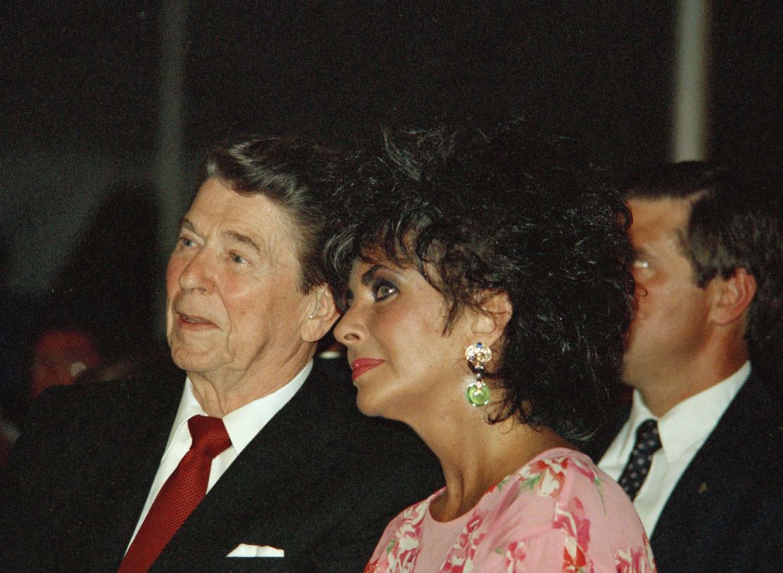 President Ronald Reagan sits with actress Elizabeth Taylor during her American Foundation for AIDS Research dinner in Washington on May 31, 1987.