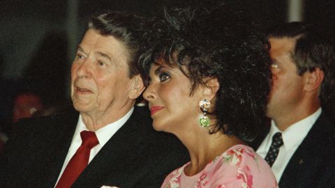 President Ronald Reagan sits with actress Elizabeth Taylor during her American Foundation for AIDS Research dinner in Washington on May 31, 1987.