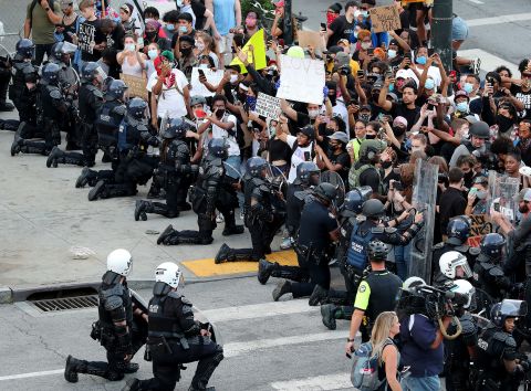 Law enforcement officers kneel with protesters in Atlanta on June 1.