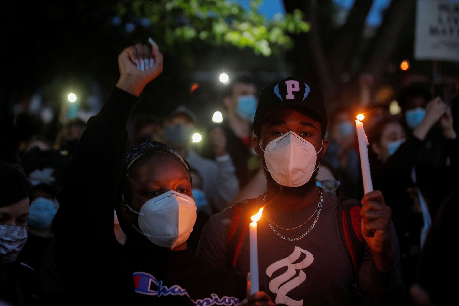 People attend a candlelight vigil at Queens Park in New York on June 1.