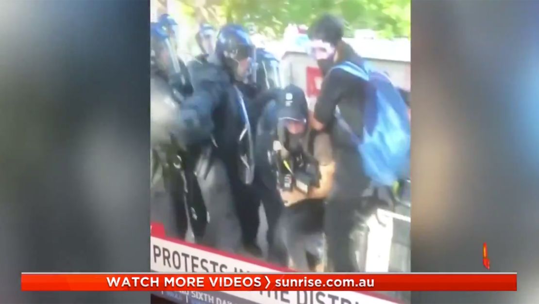 Australian journalists shown under attack by police.