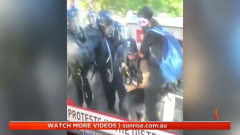 Australian journalists shown under attack by police.