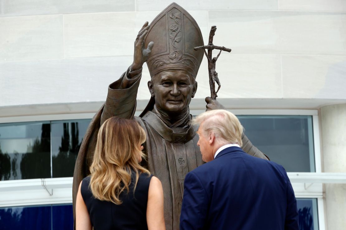 President Trump and first lady Melania Trump view a statue of Pope John Paul II on Tuesday in Washington.