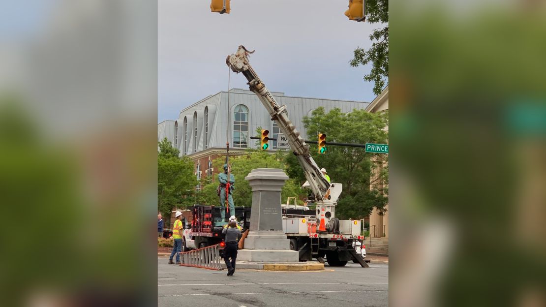 Crews in historic Old Town Alexandria are seen removing a bronze statue of a Confederate soldier.