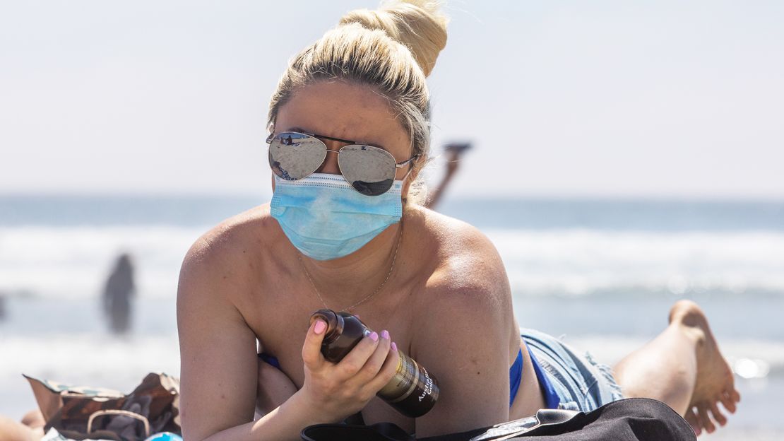 A woman sunbathes on Huntington Beach, California, on April 25, 2020.